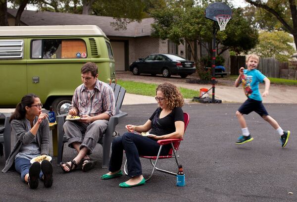 Friends and neighbors gather for a Friendsgiving potluck at a cul-de-sac in South Austin.