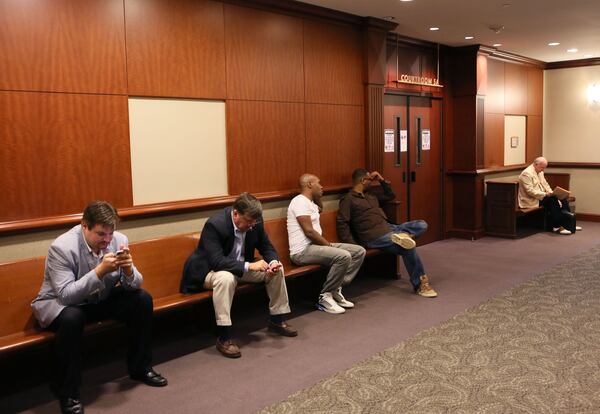 People wait outside the courtroom at Atlanta Municipal Court before the doors are opened for 8 a.m. cases. BOB ANDRES / BANDRES@AJC.COM