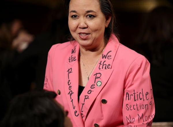 Rep. Jill Tokuda, D-Hawaii, wears a jacket with writing of the U.S. Constitution on the floor of the U.S. House of Representatives before President Donald Trump addresses a joint session of Congress at the Capitol in Washington, Tuesday, March 4, 2025. (Win McNamee/Pool Photo via AP)