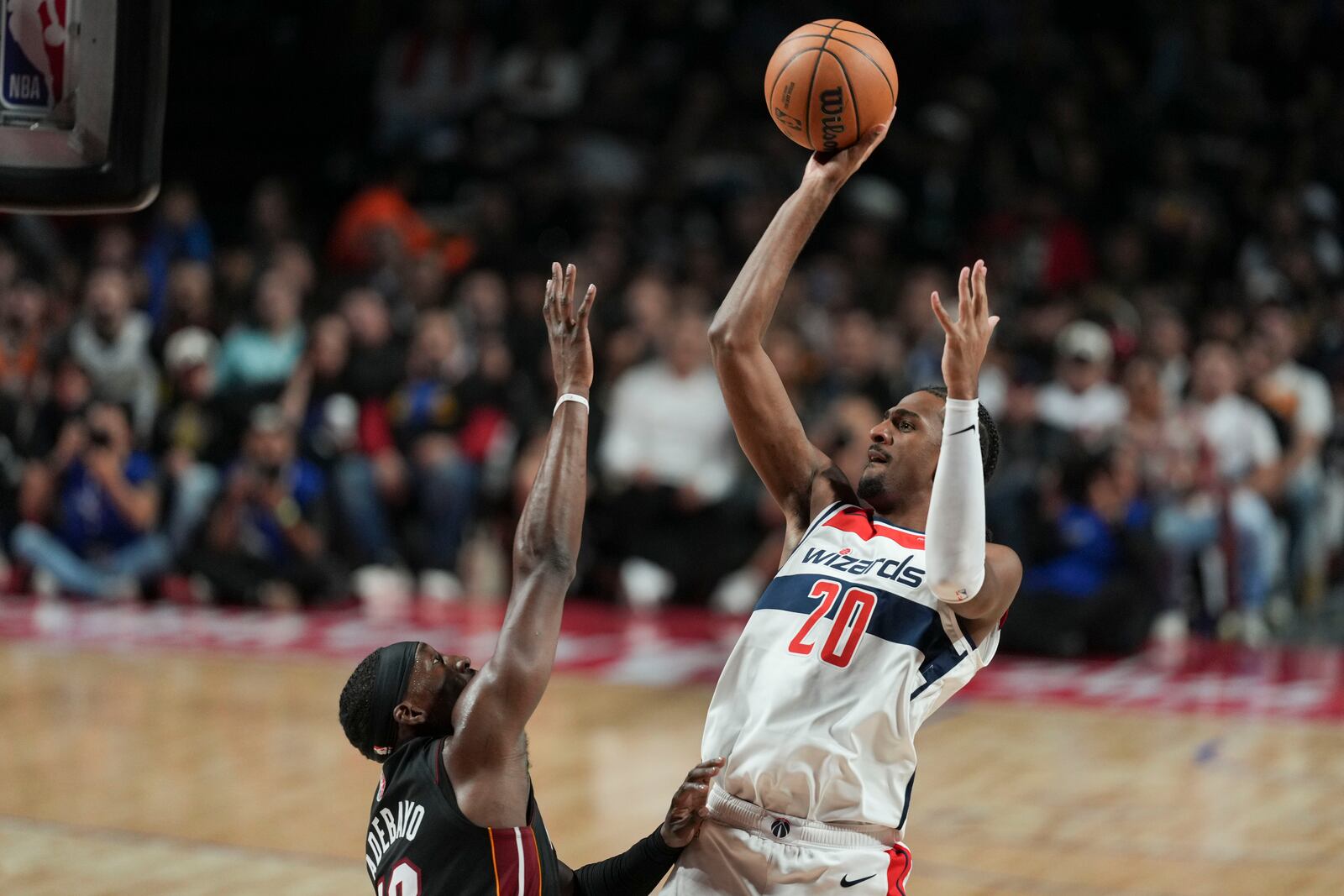 Washington Wizards Alexandre Sarr, right, shoots against Miami Heat Bam Adebayo during the first half of an NBA basketball game, at the Mexico Arena in Mexico City, Saturday, Nov. 2, 2024. (AP Photo/Fernando Llano)