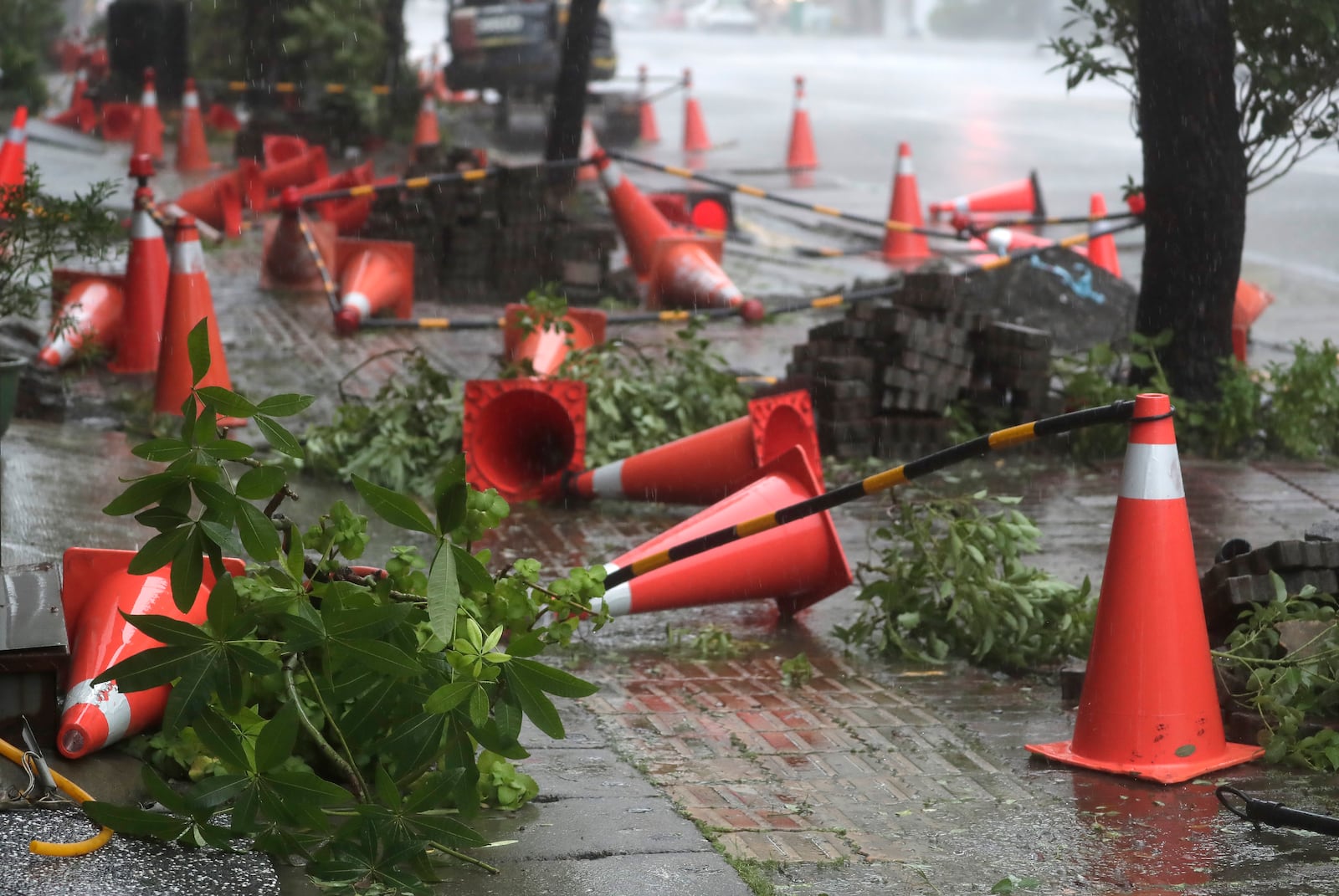 Traffic cones litter the pavement as Typhoon Krathon arrives in Kaohsiung, southern Taiwan, Thursday, Oct. 3, 2024. (AP Photo/Chiang Ying-ying)