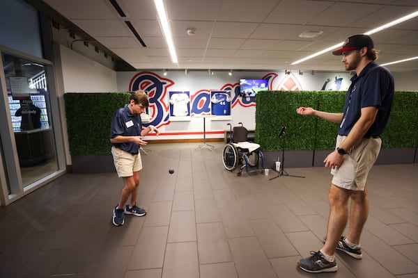 Atlanta Braves greeter Wilson Barron bounces a ball with his job coach Thomas Weingartner in an elevator lobby before the Braves play the New York Mets at Truist Park, Tuesday, Sept. 24, 2024, in Atlanta. (Jason Getz / AJC)

