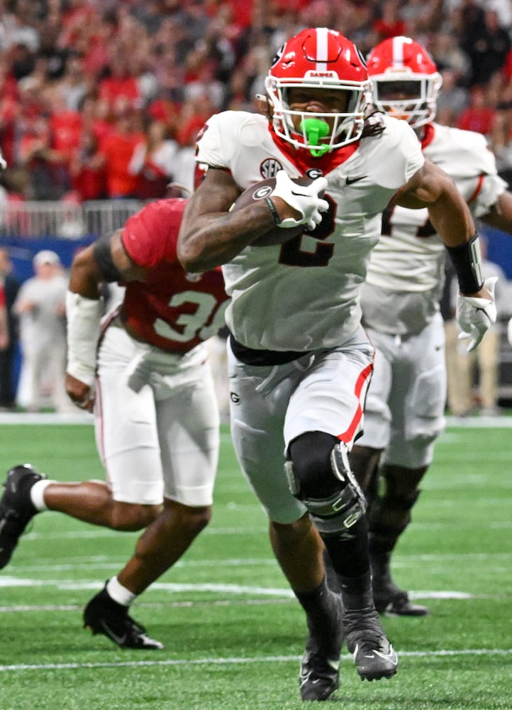 Georgia Bulldogs running back Kendall Milton (2) runs for a 17 yard touchdown against the Alabama Crimson Tide during the first half of the SEC Championship football game at the Mercedes-Benz Stadium in Atlanta, on Saturday, December 2, 2023. (Hyosub Shin / Hyosub.Shin@ajc.com)