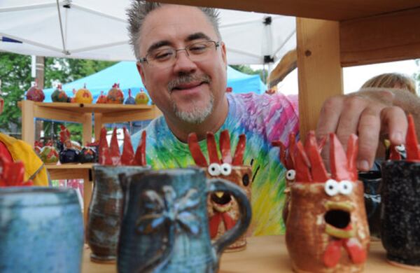 Artist Tommy McClure displays his chicken pottery.