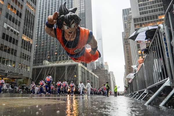 Handlers guide the Goku balloon down Sixth Avenue during the Macy's Thanksgiving Day Parade, Thursday, Nov. 28, 2024, in New York. (AP Photo/Julia Demaree Nikhinson)