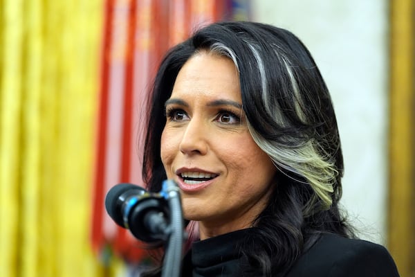 FILE - Director of National Intelligence Tulsi Gabbard listens to President Donald Trump during her swearing-in at the Oval Office of the White House, Feb. 12, 2025, in Washington. (Photo/Alex Brandon, File)