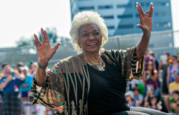 LIVING LONG AND PROSPERING--September 5, 2015 Atlanta - Nichelle Nichols, who played communications officer Lieutenant Uhura aboard the USS Enterprise in the popular Star Trek television series and succeeding motion pictures, gives the Vulcan symbol of live long and prosper as she rides down Peachtree St. during the annual DragonCon Parade in Atlanta on Saturday, September 5, 2015. JONATHAN PHILLIPS / SPECIAL