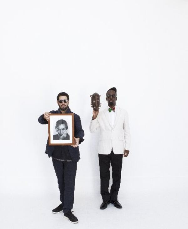 Jose Parla (left) and Fahamu Pecou (right). Parla is holding a portrait of Wifredo Lam by Man Ray. Brooklyn artist Parla and Atlantan Pecou have solo exhibits opening Feb. 14 at the High Museum that respond to the art of Cuban-born Surrealist Lam, the subject of a major High retrospective also opening Feb. 14. CONTRIBUTED BY REY PARLA