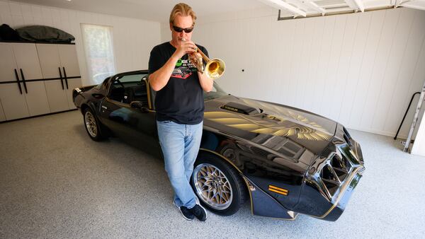 Musician Joe Gransden was spotted playing his trumpet next to his meticulously restored 1979 Pontiac Trans Am in his home’s garage. After a decade of searching, he finally reclaimed his cherished Trans Am from the restorer. (Miguel Martinez / AJC)