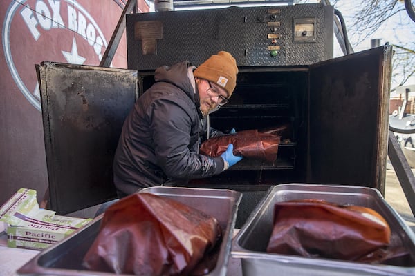  Smokehouse supervisor Craig Hoelzer takes a batch of brisket out of a smoker at Fox Bros Bar-B-Q near Atlanta’s Little Five Points community, Friday, January 25, 2019. (ALYSSA POINTER/ALYSSA.POINTER@AJC.COM)