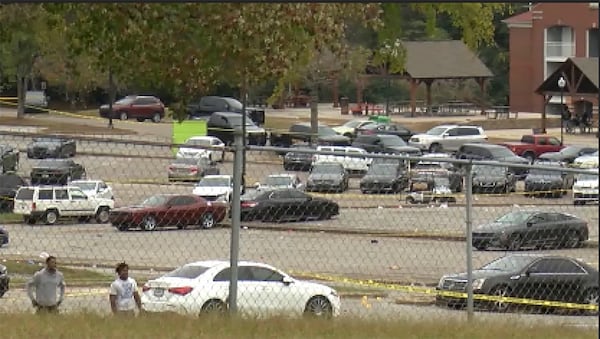 This image taken from video provided by WSFA shows people standing by the scene of an earlier shooting at Tuskegee University, Sunday, Nov. 10, 2024, in Tuskegee, Ala. (WSFA via AP)