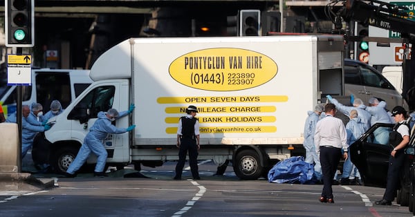 FILE - Forensic officers move the van at Finsbury Park in north London, where a vehicle struck pedestrians in north London Monday, June 19, 2017. (AP Photo/Frank Augstein, File)