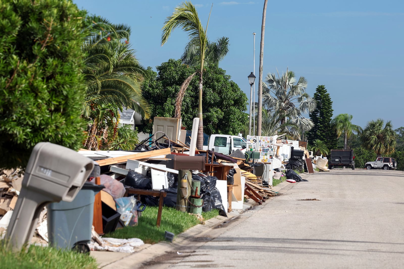 Debris from homes flooded in Hurricane Helene sits curbside as Hurricane Milton approaches on Tuesday, Oct. 8, 2024, in Port Richey, Fla. (AP Photo/Mike Carlson)