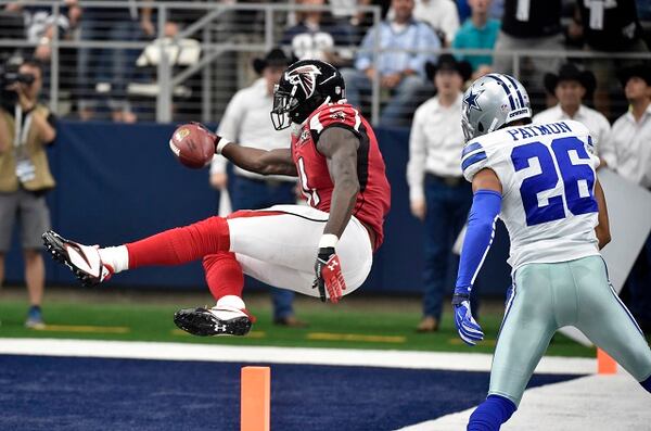 Atlanta Falcons wide receiver Julio Jones (11) sails into the end zone for a touchdown as Dallas Cowboys defensive back Tyler Patmon (26) watches in the second half of an NFL football game on Sunday, Sept. 27, 2015, in Arlington, Texas. (AP Photo/Michael Ainsworth)