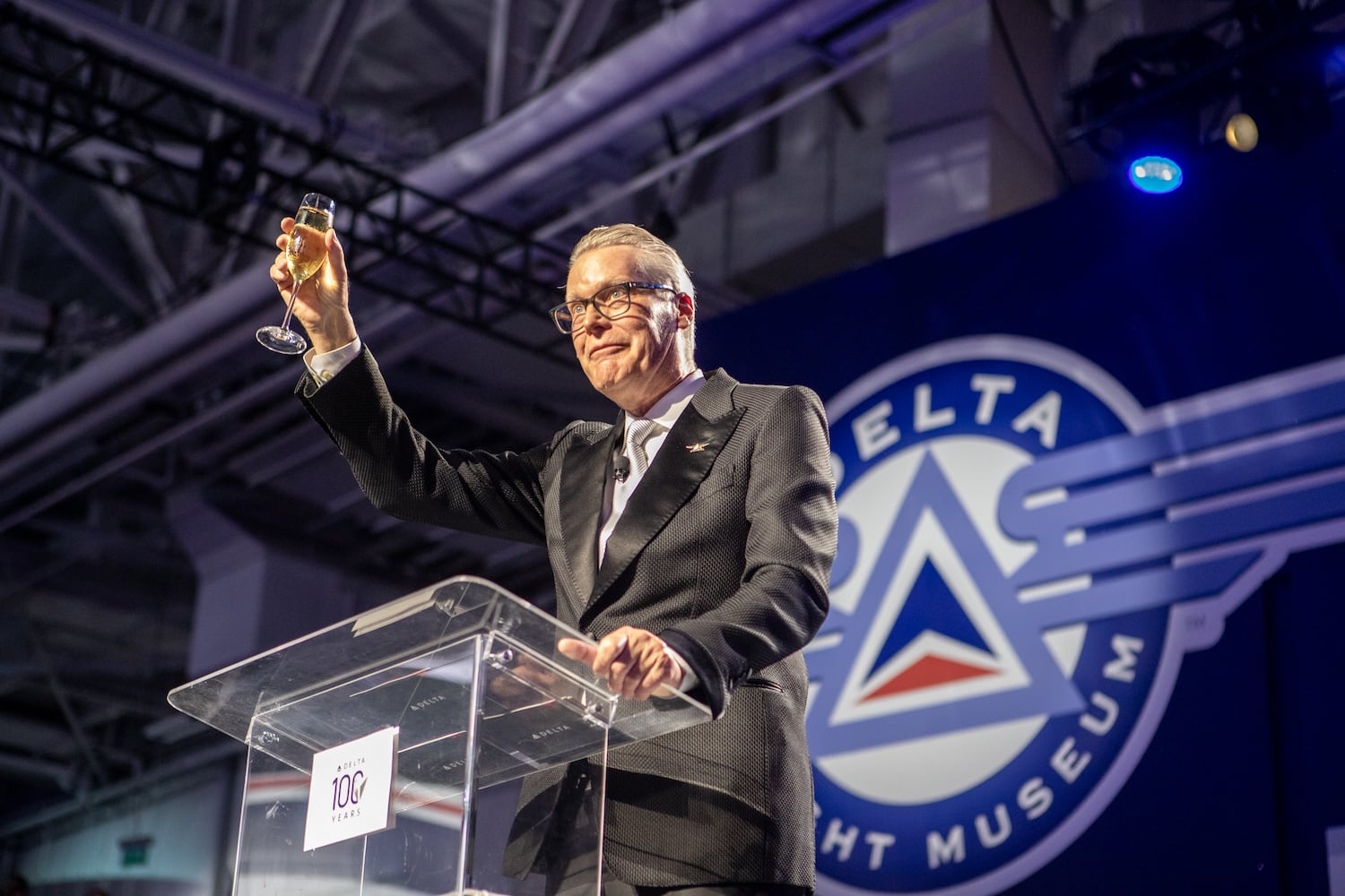 Delta Airlines CEO Ed Bastian is on stage and toasts the customers, employees and previous leaders of the organization as Delta celebrates its 100 year anniversary on Saturday, March 15, 2025 at the Delta Flight Museum. (Jenni Girtman for The Atlanta Journal-Constitution)