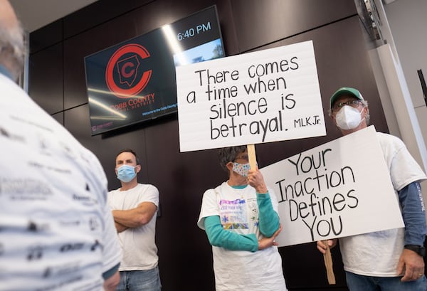  Karen Melnick and her husband Larry Melnick protest outside of the Cobb County School Board meeting Thursday evening, Sept. 23, 2021, after antisemitic vandalism was discovered at two Cobb County High Schools. Karen Melnick is a retired Cobb teacher and is a member of Temple Kol Emeth in Marietta.  Ben Gray for the Atlanta Journal-Constitution