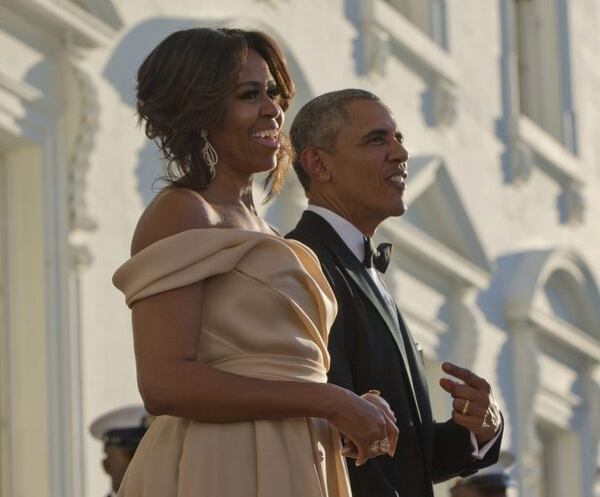 President Barack Obama points towards first lady Michelle Obama as they wait for the arrival of Nordic Leaders on the North Portico for a State Dinner at the White House in Washington, Friday, May 13, 2016. (AP Photo/Pablo Martinez Monsivais)