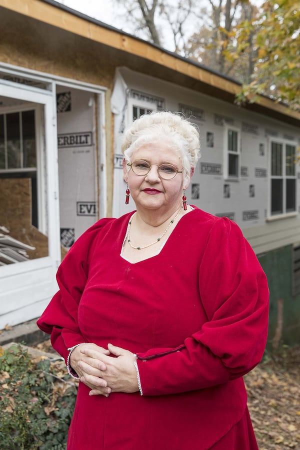 11/22/2019 — Atlanta, Georgia — Entertainer Christine Seelye-King, 58, who transforms into Mrs. Claus during the holiday season, stands in front of her residence, which is being reconstructed in Atlanta’s Ormewood Park neighborhood, following a fire. (Alyssa Pointer/Atlanta Journal Constitution)