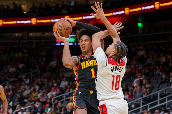 Atlanta Hawks forward Jalen Johnson (1) gets the rebound over Washington Wizards forward Kyshawn George (18) during the first half of an Emirates NBA Cup basketball game, Friday, Nov. 15, 2024, in Atlanta. (AP Photo/Jason Allen)