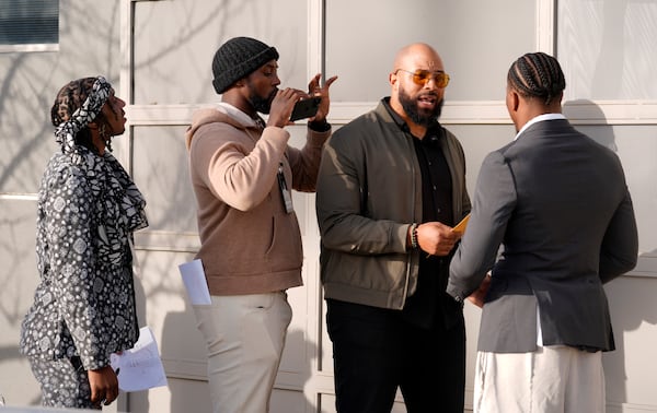 Retired NFL player T.J. Wright, left, and current NFL player Charles Harris, second from left, direct retired NFL player Copeland Bryan, second from right, and current NFL player Daiyan Henley as they film a scene from the film "Meet the Blacks" during a filmmaking workshop for NFL players on Tuesday, March 4, 2025, in Santa Monica, Calif. (AP Photo/Chris Pizzello)