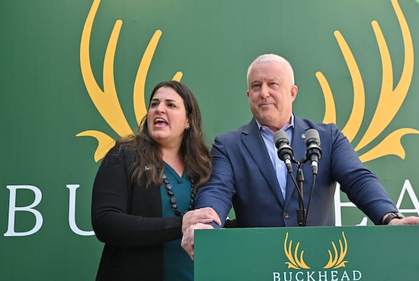 Leila Laniado (left), secretary of the Buckhead City Committee, holds Bill White, the group's chairman and CEO, as she speaks to members of the press during a news conference on Tuesday, February 18, 2022. (Hyosub Shin / Hyosub.Shin@ajc.com)