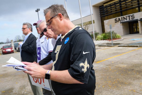 Members of SNAP,  including John Gianoli, left, John Anderson, Richard Windmann and Kevin Bourgeois, read a news release from the New Orleans Saints, who deny involvement in trying to cover up a scandal.