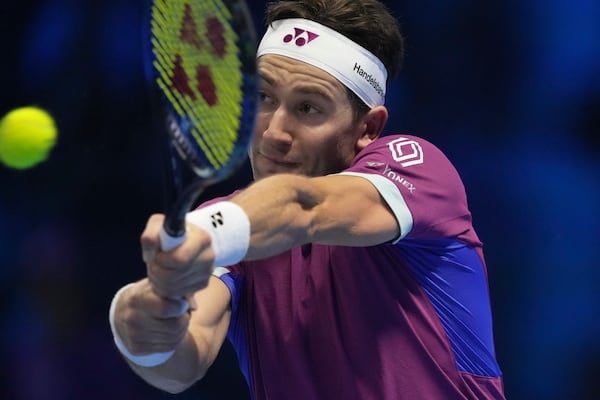 Denmark's Casper Ruud returns the ball to Spain's Carlos Alcaraz during their singles tennis match of the ATP World Tour Finals at the Inalpi Arena, in Turin, Italy, Monday, Nov. 11, 2024. (AP Photo/Antonio Calanni)