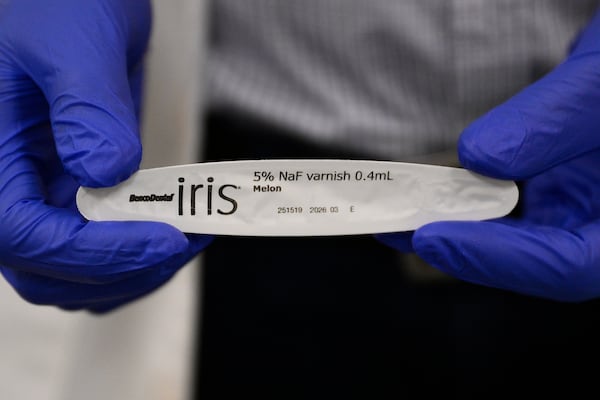 Alexander Daniel, DDS, holds a sample of fluoride at the Johns Hopkins Outpatient Center, Friday, Feb. 28, 2025, in Baltimore. (AP Photo/Nick Wass)