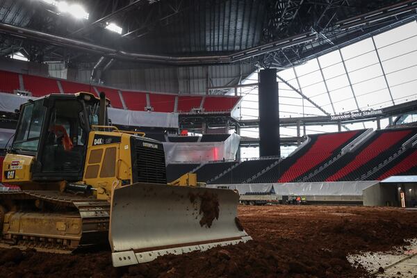 Workers were transforming the floor of Mercedes-Benz Stadium from a football field to a monster trucks track Wednesday.