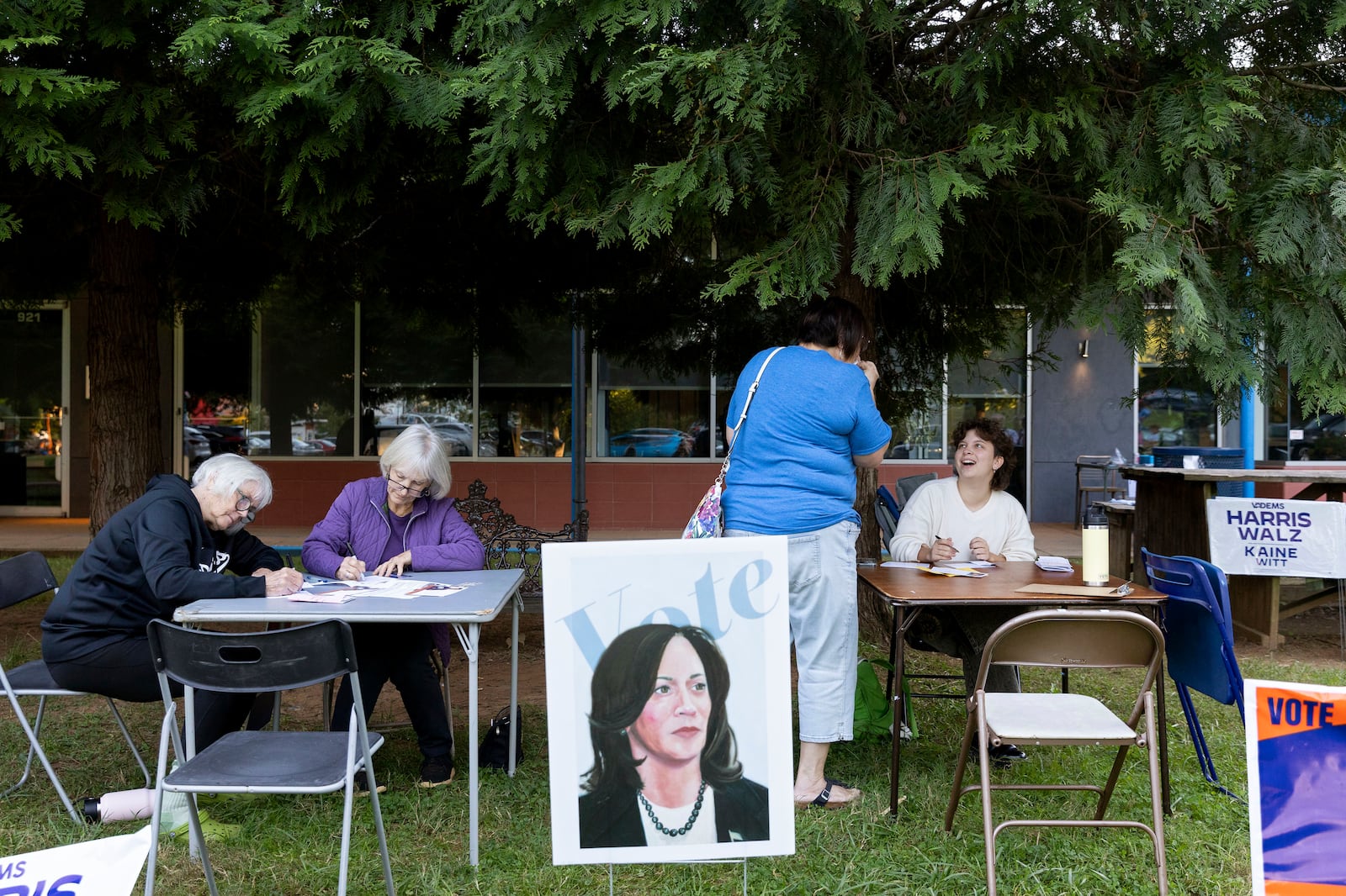 Ellen Shrum, Jeanette Rosenberg, Nancy Gulotta and Cannon Slayton write postcards at IX Art Park in Charlottesville, Va., Thursday, Oct. 10, 2024. Charlottesville Democrats meet weekly to make phone calls, write postcards and send texts to get out the vote. (AP Photo/Ryan M. Kelly)