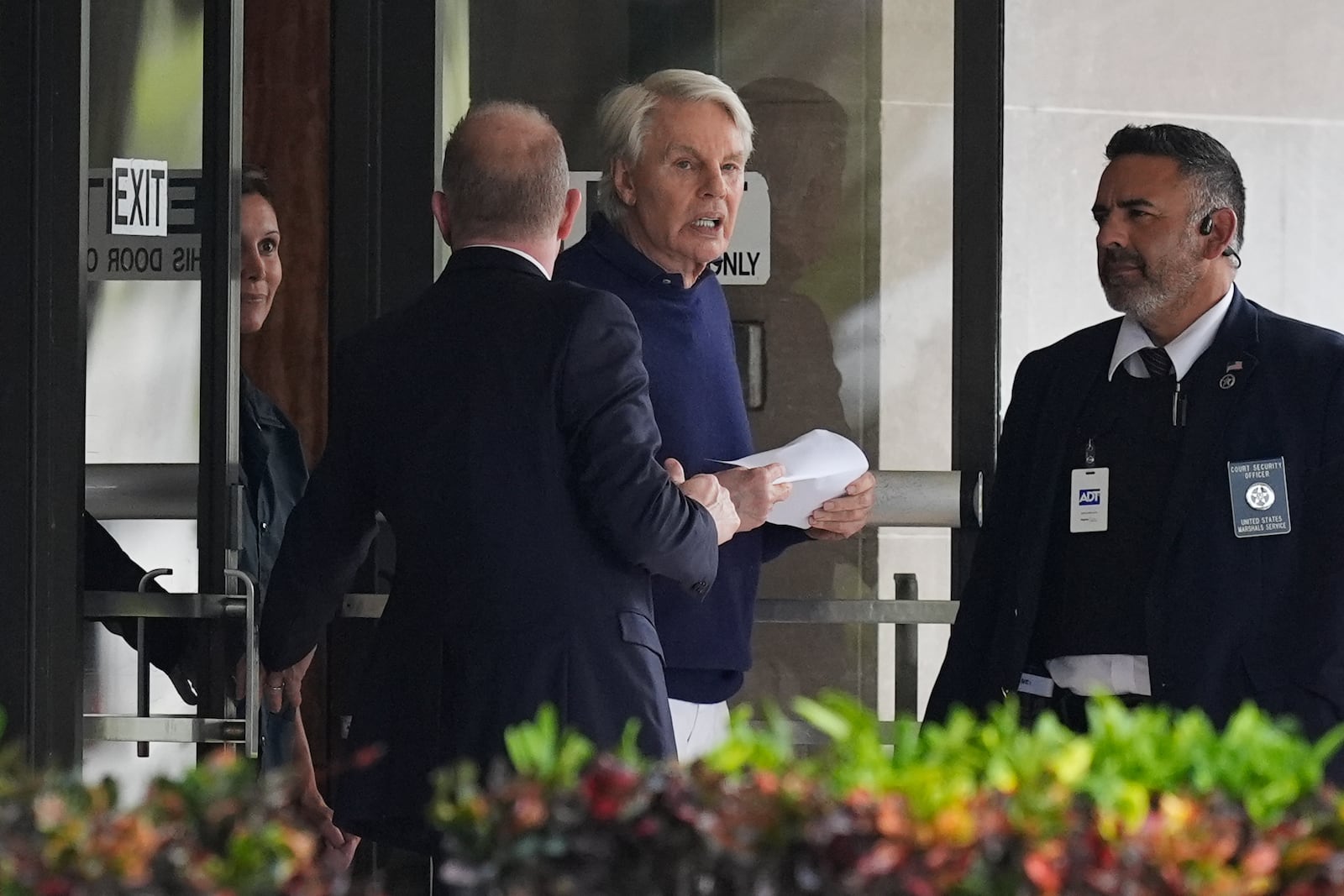 Michael Jeffries, center, former CEO of Abercrombie & Fitch, leaves the Paul G. Rogers Federal Building and U.S. Courthouse following a hearing, in West Palm Beach, Fla., Tuesday, Oct. 22, 2024. (AP Photo/Rebecca Blackwell)