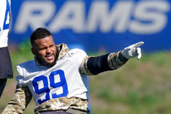 Los Angeles Rams defensive end Aaron Donald gesture prior to practice for an NFL Super Bowl football game Wednesday, Feb. 9, 2022, in Thousand Oaks, Calif. The Rams are scheduled to play the Cincinnati Bengals in the Super Bowl on Sunday. (AP Photo/Mark J. Terrill)