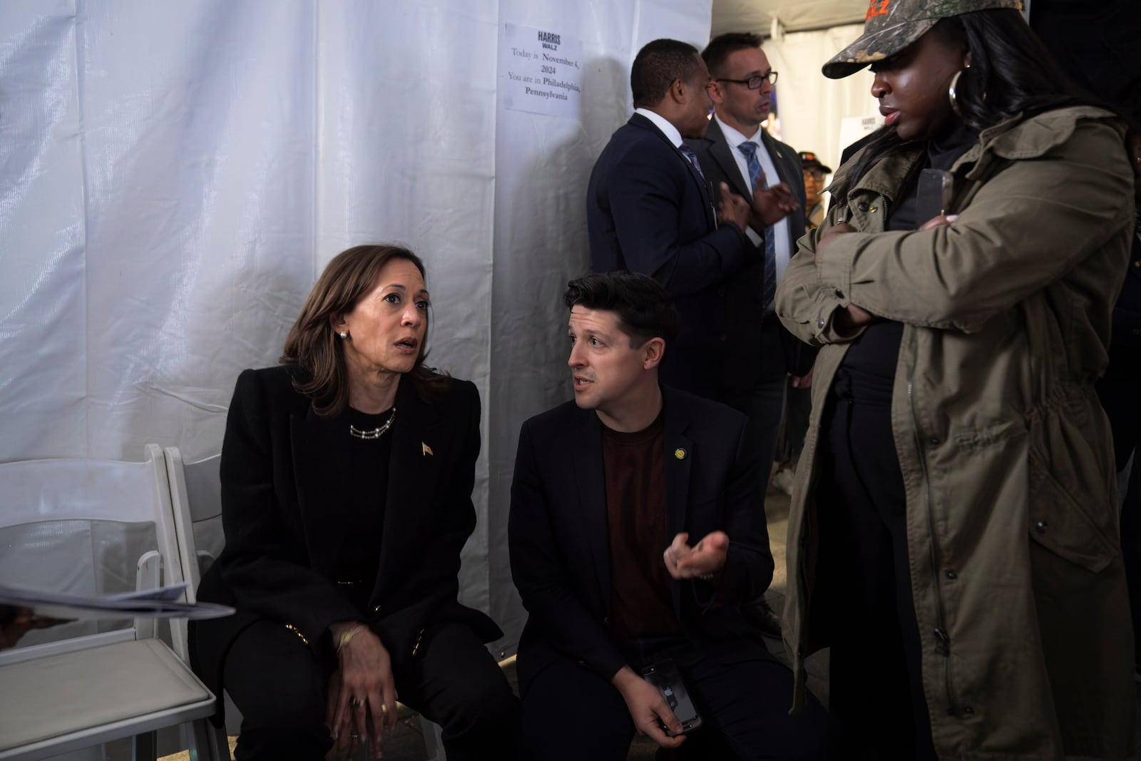 Democratic presidential nominee Vice President Kamala Harris, left, speaks with Ike Irby, senior advisor to the vice president, and Kirsten Allen, communications director to the vice president, shortly before taking the stage for Harris' final campaign rally, Monday, Nov. 4, 2024, in Philadelphia. (AP Photo/Jacquelyn Martin)