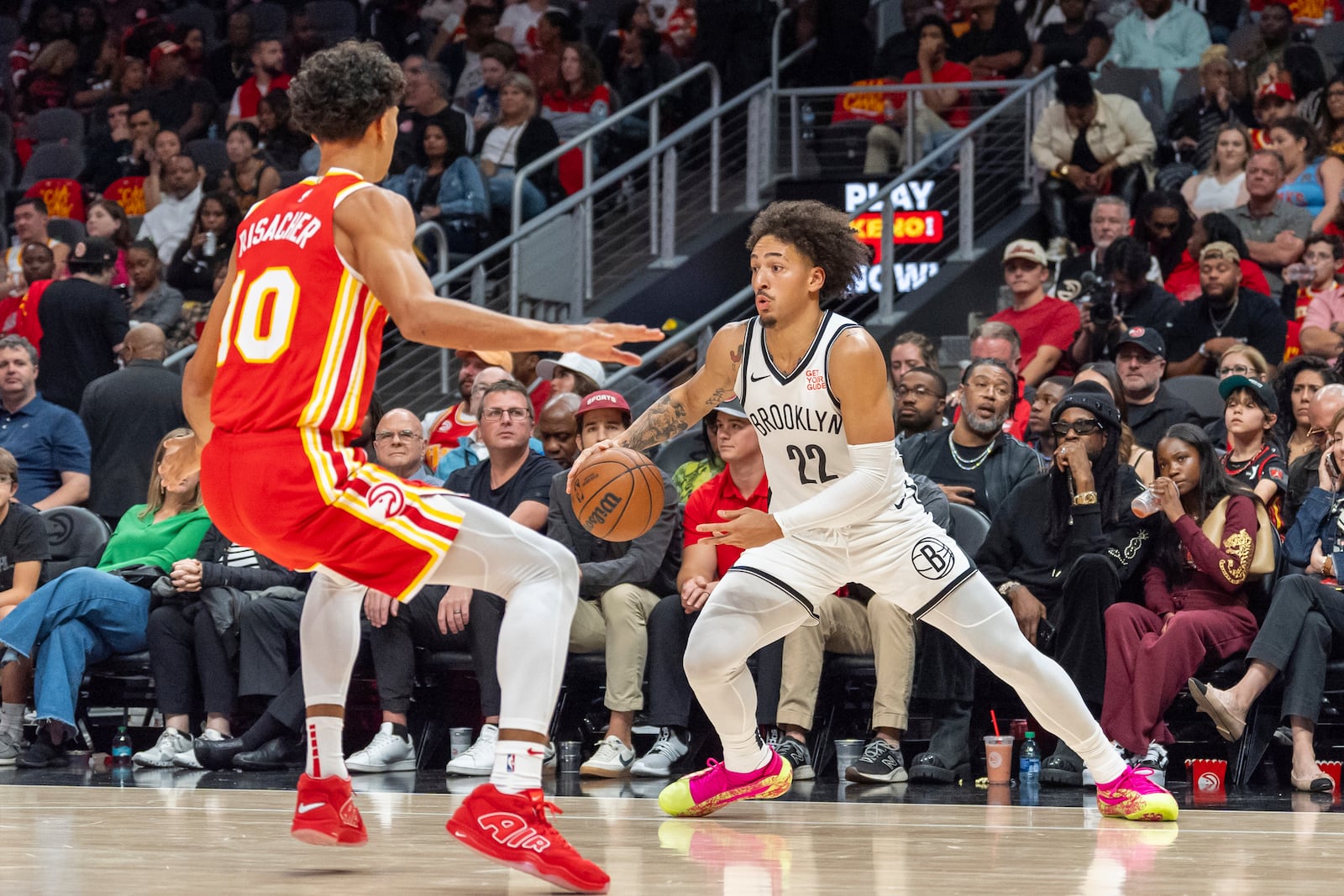 Brooklyn Nets forward Jalen Wilson (22) dribbles the ball while guarded by Atlanta Hawks forward Zaccharie Risacher (10) during the second half of an NBA basketball game, Wednesday, Oct. 23, 2024, in Atlanta. (AP Photo/Jason Allen)