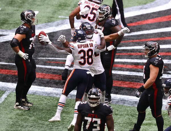 Falcons players are stunned as Chicago Bears defensive back Tashaun Gipson Sr. (left) celebrates with Khalil Mack after intercepting a Matt Ryan in the final minutes of the fourth quarter to secure a 30-26 come-from-behind win over Falcons Sunday, Sept. 27, 2020, at Mercedes-Benz Stadium in Atlanta. (Curtis Compton / Curtis.Compton@ajc.com)