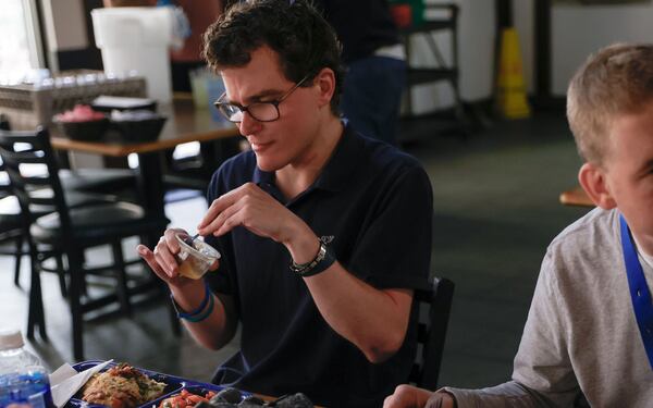 Joey Milstein eats lunch in the cafeteria at Annandale Village.  (Natrice Miller/ AJC)