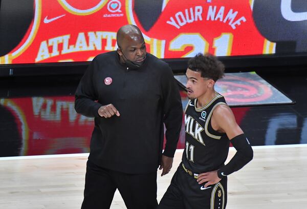 Hawks interim head coach Nate McMillan confers with Hawks guard Trae Young (11) during the first half against the Phoenix Suns May 5, 2021, at State Farm Arena in Atlanta. (Hyosub Shin / Hyosub.Shin@ajc.com)