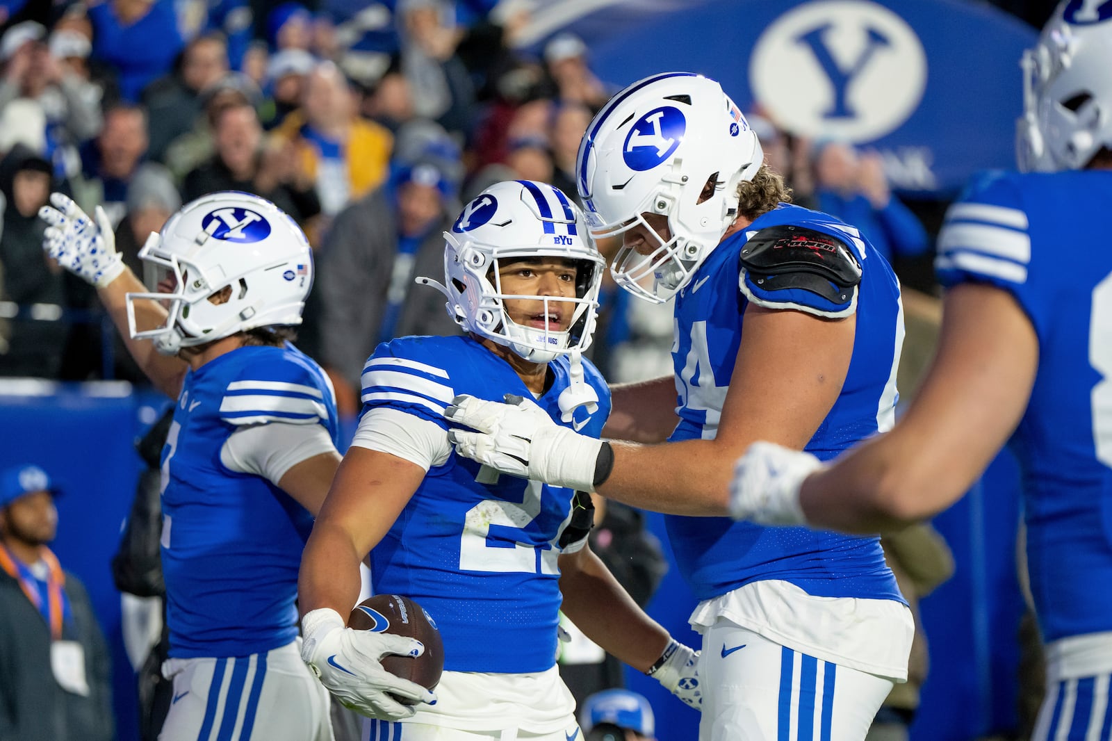 BYU running back LJ Martin, second from left, celebrates after scoring a touchdown in the second half of an NCAA college football game against Oklahoma State, Friday, Oct. 18, 2024, in Provo, Utah. (AP Photo/Spenser Heaps)