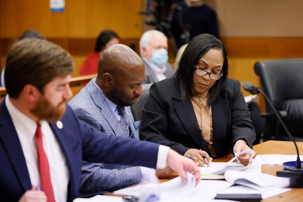 Fulton County District Attorney Fani Willis (right) interacts with colleagues Donald Wakeford (left) and Nathan Wade (center) during a hearing on Jan. 24, 2023. Miguel Martinez / miguel.martinezjimenez@ajc.com