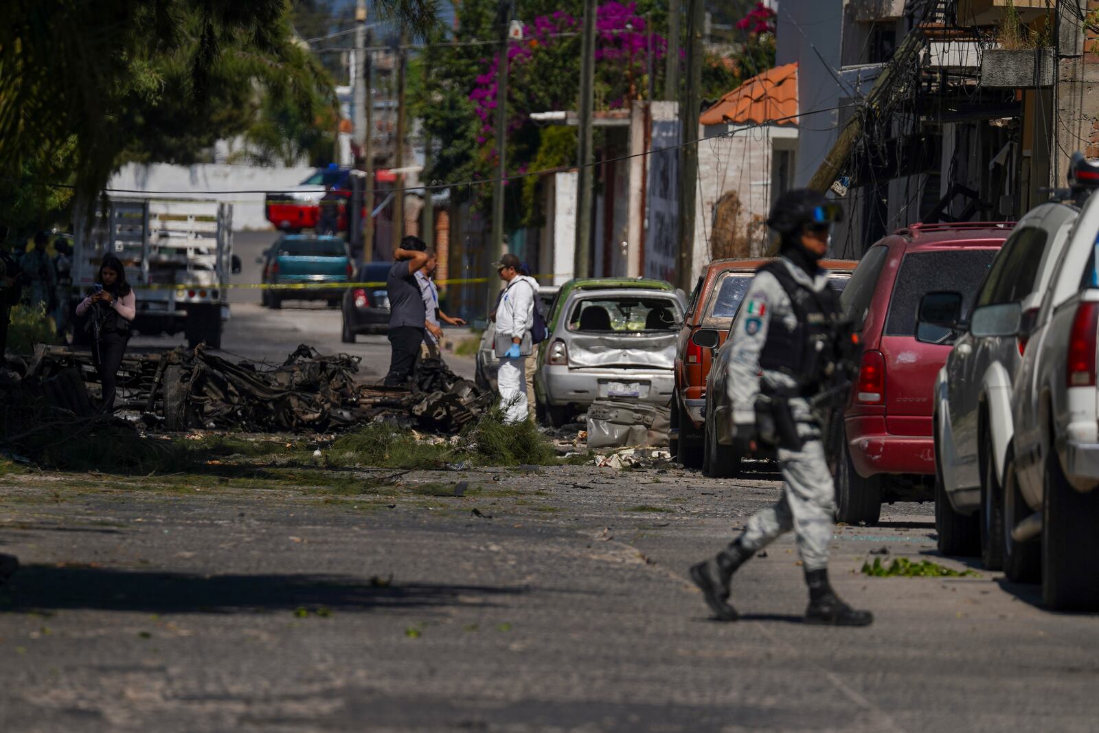 Security agents and experts on the scene where a car bomb exploded near a police station, in Acambaro, Guanajuato state, Mexico, Thursday, Oct. 24, 2024. (AP Photo/Armando Solis)