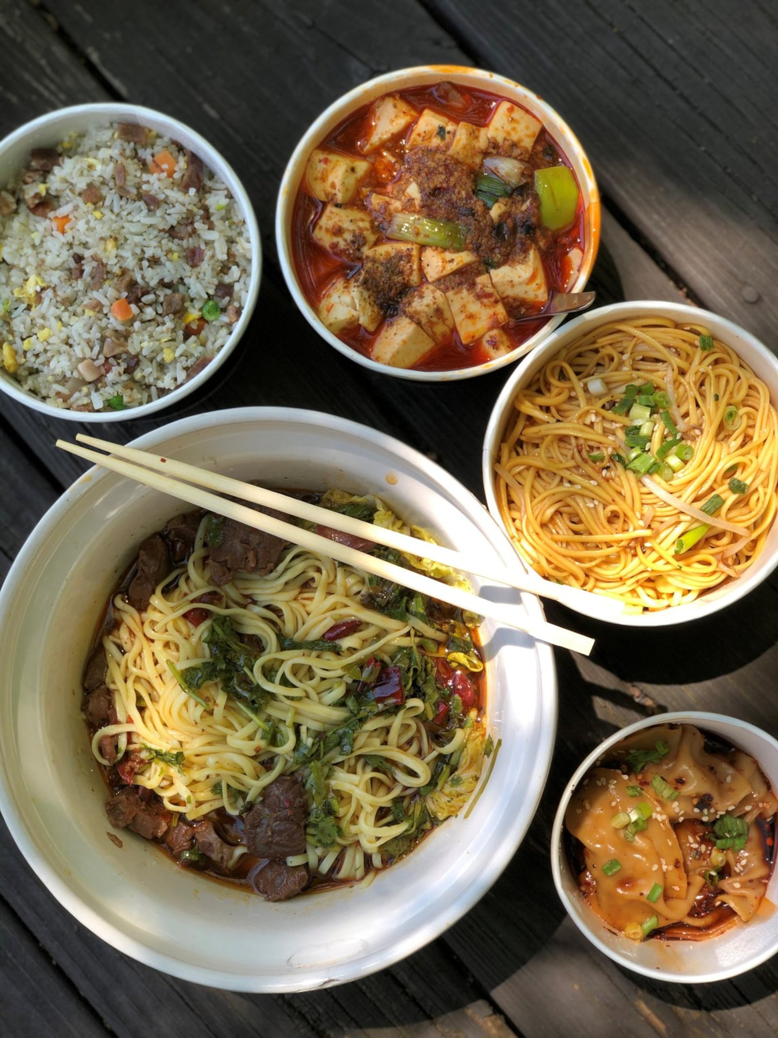 A selection of takeout dishes from Gu’s Kitchen (clockwise from top right): mapo tofu; cold Chengdu noodles; Sichuan beef noodles; and pork belly fried rice. CONTRIBUTED BY WENDELL BROCK