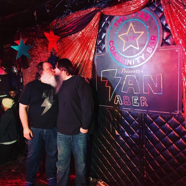 Ian Aber and husband Payne Broome kiss for luck on the night of Aber's album recording at Star Bar in 2019.