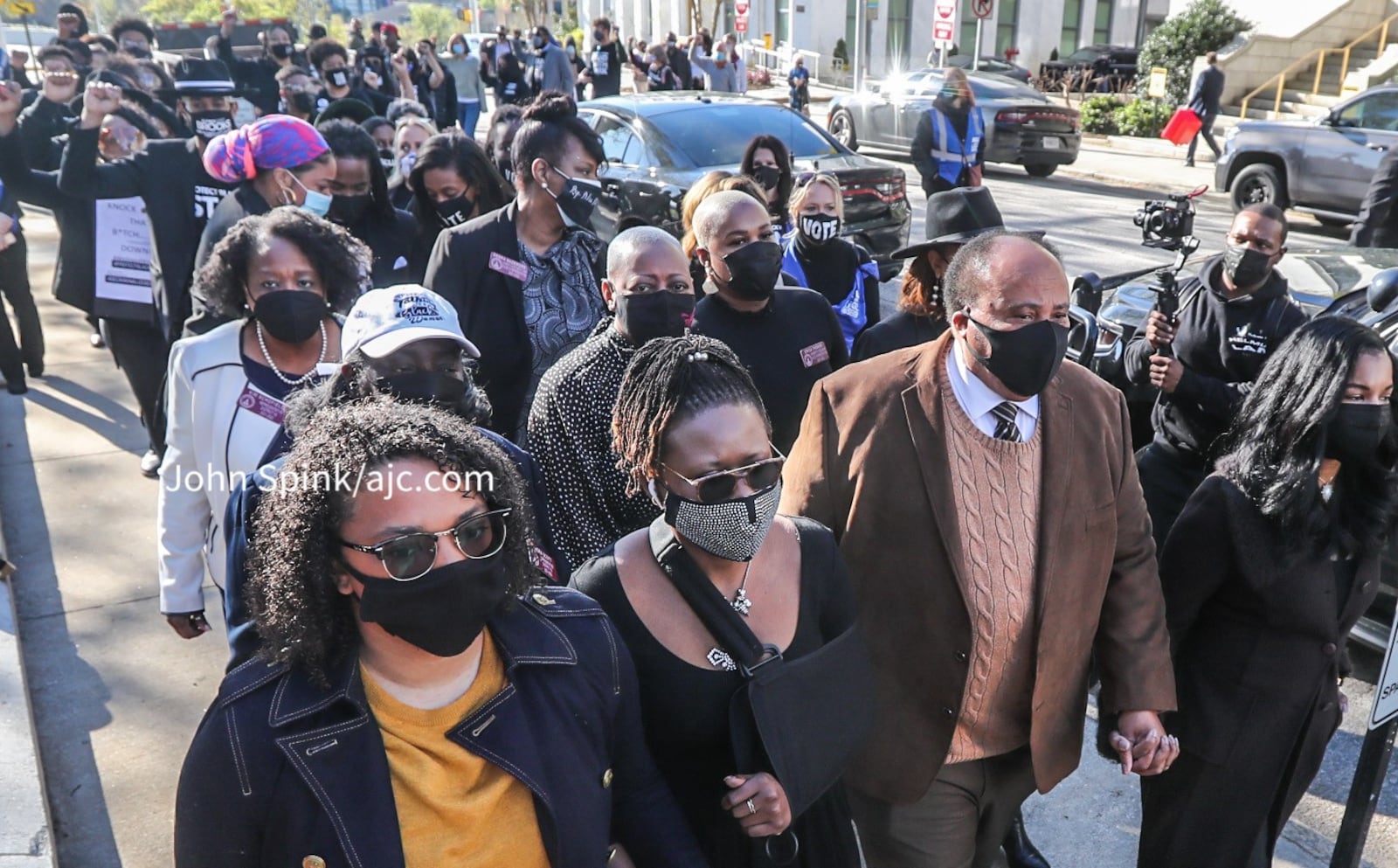 State Rep. Park Cannon walks to the Capitol on Monday with Martin Luther King III at her side.