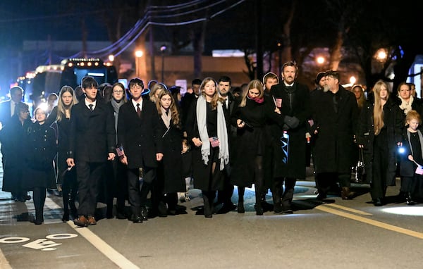 Members of the Carter family follow the hearse carrying former President Jimmy Carter to his private interment in Plains.