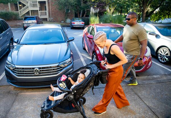 Akil Sanders, right, with his wife, Stefanie, and their daughter, Nola, walking in their Old Fourth Ward neighborhood. Sanders said: “Atlanta is growing, growing, growing and I want my property value to continually be worth something and I want my kids to be able to go schools in nice places. And I want my friends’ kids to be able to go to schools in nice places and feel safe.”  (Jenni Girtman for The Atlanta Journal-Constitution)