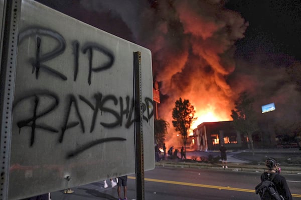 June 13, 2020 -  Atlanta -  Wendy's in flames, after demonstrators blocked the interstate and set it on fire.     Protestors gather at University Ave. at the Atlanta Wendy's where Rayshard Brooks, a 27-year-old black man,  was shot and killed by Atlanta police Friday evening during a struggle in a Wendy’s drive-thru line.    Ben Gray for the Atlanta Journal Constitution