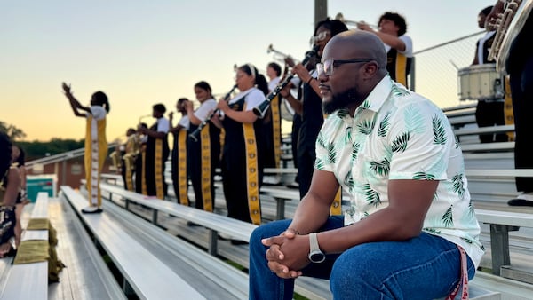 Ernest Stackhouse, director of the Twiggs County High Marching Cobras band, at the school's first home football game of the 2024 season. (Joe Kovac Jr. / AJC)