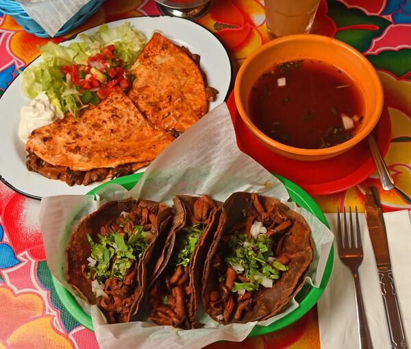 Quesadillas and tacos filled with Mushroom Birria (a recipe created by Roberto Montalvo, general manager at El Ponce restaurant). Also shown is the broth that is served on the side. (Styling by Roberto Montalvo / Chris Hunt for the AJC)