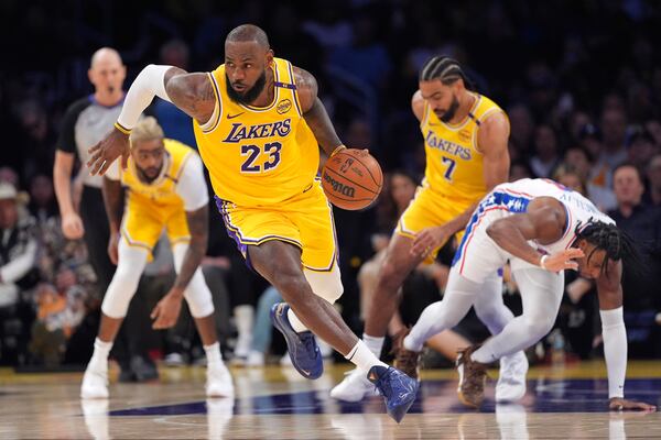 Los Angeles Lakers forward LeBron James, second from right, drives with the ball after stealing it from Philadelphia 76ers guard Ricky Council IV, right, during the first half of an NBA basketball game, Friday, Nov. 8, 2024, in Los Angeles. (AP Photo/Mark J. Terrill)