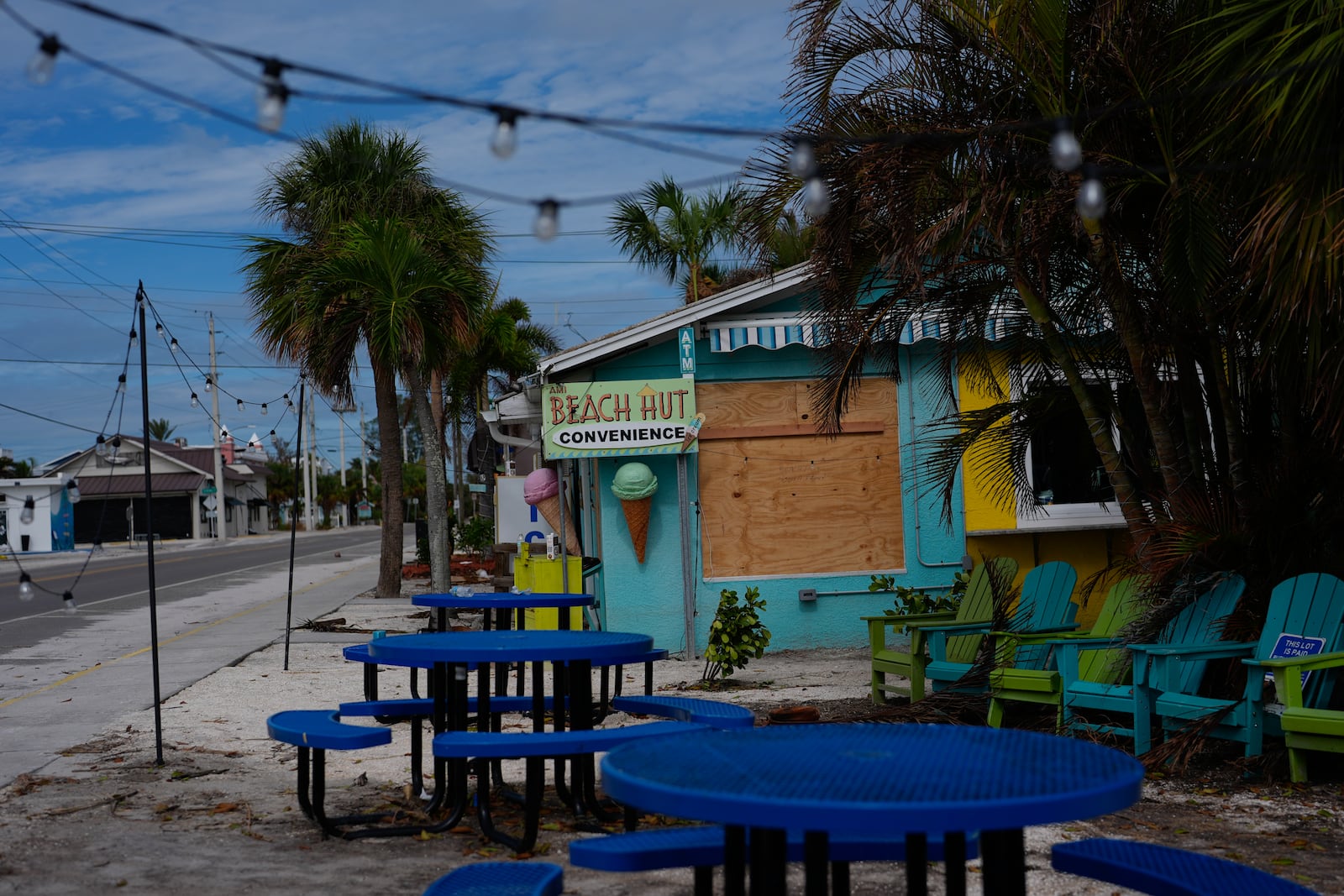 A boarded up business stands beside a deserted street in an evacuation zone, ahead of the arrival of Hurricane Milton, in Anna Maria, Fla., on Anna Maria Island, Tuesday, Oct. 8, 2024. (AP Photo/Rebecca Blackwell)